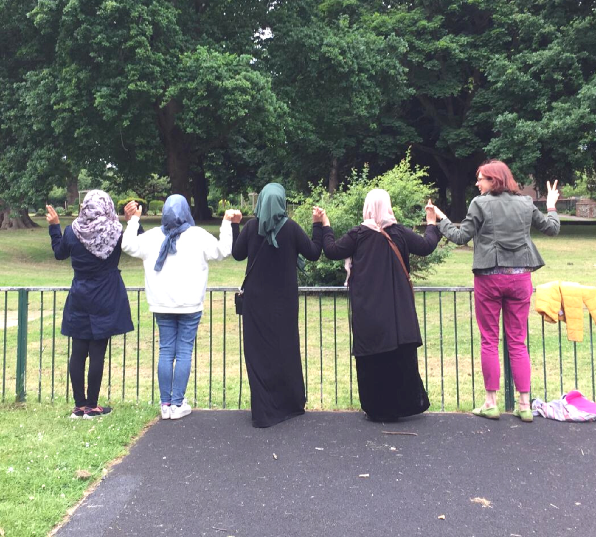 Women refugees in Croydon holding hands